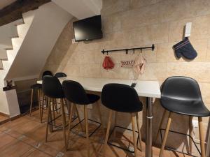 a bar with black stools in a room at La Cantarera del Duero in Tordesillas