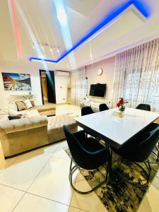 a living room with a table and a couch at Two bedroom luxury apartment in Accra
