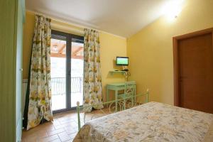 a bedroom with a bed and a window with a television at B&B Land & Sea in Campofilone