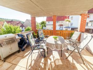 a patio with a table and chairs and a grill at Wohnung in Densberg nahe Kellerwald in Densberg