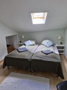 a bedroom with a large bed with blue pillows at Mariustova close to the airport in Ryggur