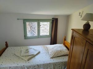 a bedroom with a bed and a window at Maison corse - cap corse in Sisco +10 photos