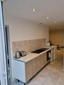una cocina con una encimera con dos ollas. en VALSCOSY parking - Activités illégales interdite, en Valenciennes