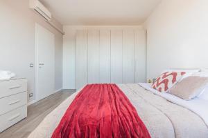 a bedroom with a large bed with a red rug on it at The Purple House between Modena and the Ferrari Museum in Modena