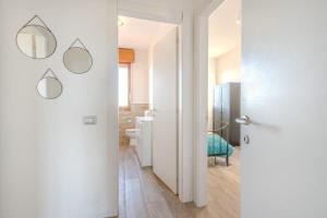 a hallway with a bathroom with a toilet and a mirror at The Purple House between Modena and the Ferrari Museum in Modena