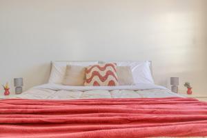 a bed with a red blanket on top of it at The Purple House between Modena and the Ferrari Museum in Modena