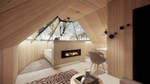 a living room with a fireplace and a chair at Vaattunki Wilderness Resort in Rovaniemi