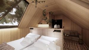 a room with a bed with white pillows at Vaattunki Wilderness Resort in Rovaniemi