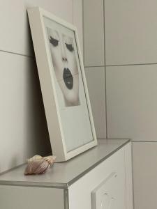 a picture frame sitting on a shelf next to a dresser at Ferienwohnung Utes Stube in Neuwied +19 photos