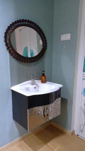 a bathroom with a sink and a mirror at The Maple Homestay @ Kota Laksamana Melaka in Melaka +45 photos