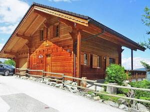 a log cabin with a car parked in front of it at Chalet in Vex near Ski Slopes in Les Collons