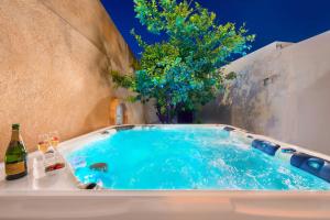 a hot tub in a backyard with a tree at Villa Eftihia in Lindos in Líndos