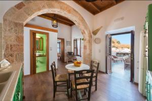 a kitchen and dining room with a table and chairs at Villa Eftihia in Lindos in Líndos