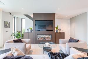 a living room with couches and a fireplace at Villa Memorias by Algarve Holidays in Páteo