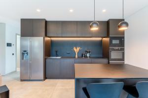 a kitchen with stainless steel appliances and a counter top at Villa Memorias by Algarve Holidays in Páteo