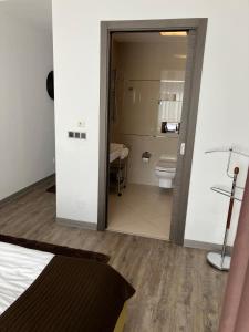 a room with a bathroom with a toilet and a bed at Silver Luxury 6 in Poiana Brasov +27 photos