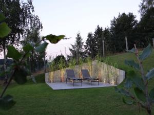 two chairs and a bench in a yard at Valley-View Retreat, Malmedy in Malmedy