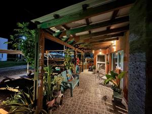 an outdoor patio with plants and a wooden pergola at Los Aromos in Federación