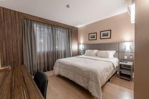 a hotel room with a bed and a window at Hotel Laghetto Moinhos in Porto Alegre +31 photos
