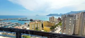 a view of a city with a harbor and buildings at Blue Beach Apartment in Ifach