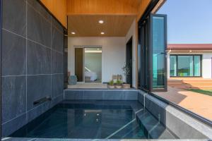 a swimming pool in the middle of a house at Gyeongju Bulguksa Family House Stay Mute in Gyeongju