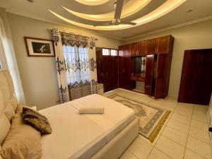 a living room with a white couch and a window at Ocean breeze apartment in Mombasa