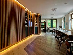 a restaurant with tables and chairs in a room at Hotel Weiss in Angermünde