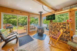 a living room with a woodburning stove and a fireplace at Spa & Waterfront Relaxation - Le Chalet EDGAU in Saint-Alban