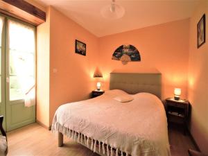 a bedroom with a large bed and a window at Peaceful Stay in Thédirac in Lavercantière