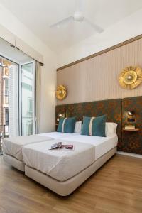 a bedroom with a large bed with a large window at Genteel Home Zaragoza in Seville