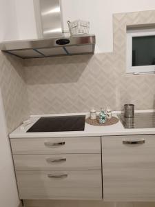 a kitchen with a stove top and a sink at villa mastroronzo in San Michele Salentino +29 photos