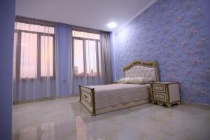 a bedroom with a bed and a blue wall at Art House in Sevan