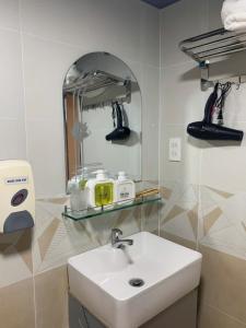 a bathroom with a sink and a mirror at Ken's House Dalat in Da Lat