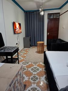 a living room with a couch and a table at Studio Apartment Naivas Mwembe tayari Cbd in Mombasa