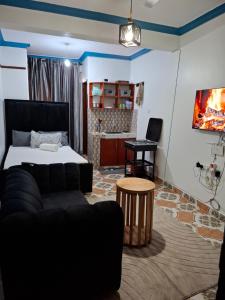 a living room with a couch and a table at Studio Apartment Naivas Mwembe tayari Cbd in Mombasa