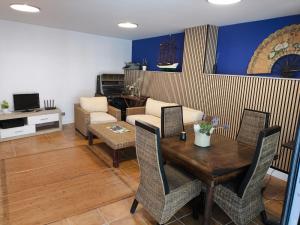 a living room with a wooden table and chairs at Hotel O Noso Portosin in Portosin
