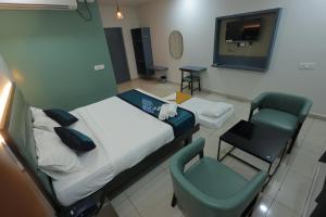 a hospital room with a bed and a chair at The Lotus Park in Srikalahasti