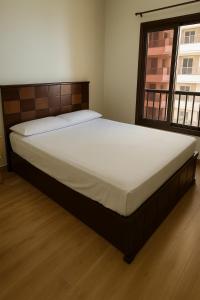 a large bed in a bedroom with a window at The park View in Alexandria