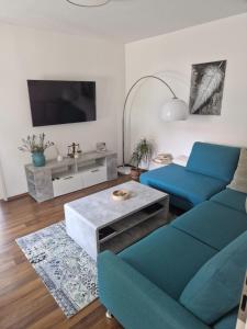 a living room with a couch and a table at Detmolder Perle in Detmold