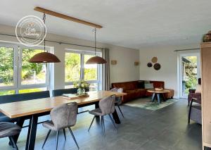 a living room with a wooden table and chairs at Villa Silberberg in Winterberg