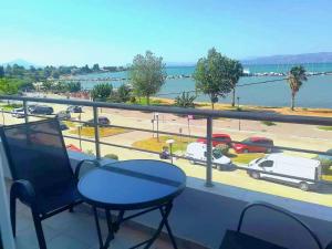 a balcony with a table and a view of a parking lot at Thalassa View c3 in Khalkoútsion