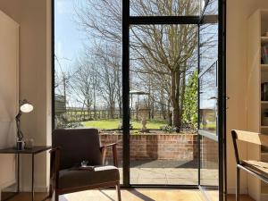 a living room with an open door to a yard at Polly's Yard in Dennington