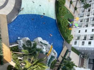 an aerial view of a pool with a water slide at Cozy Room in Modern Paraaque Condo with 2 Bedrooms in Manila +2 photos