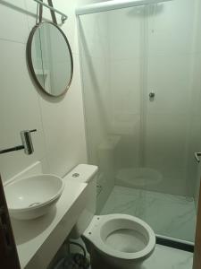 a white bathroom with a toilet and a shower at Hostel Diniz in Vitória +33 photos