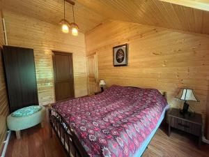 a bedroom with a bed in a wooden cabin at Shahdag Mountain Hotel in Laza +9 photos