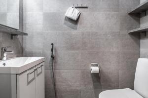 a bathroom with a toilet and a sink at Ruka Ski Chalets, Ski-In Ski-Out in Ruka