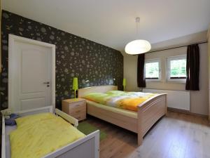 a bedroom with two beds and a window at Graceful Apartment in Velmede with Garden in Bestwig