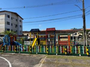 a playground with a colorful fence in a parking lot at Apartamento COP 30 soure in Marituba