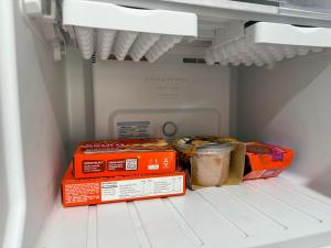 two boxes of food are sitting inside of a refrigerator at Casa inteira em Nova Mutum in Nova Mutum