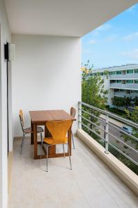 a table and chairs on a balcony with a view at 10 min walk to Rocha Beach in Portimão +4 photos